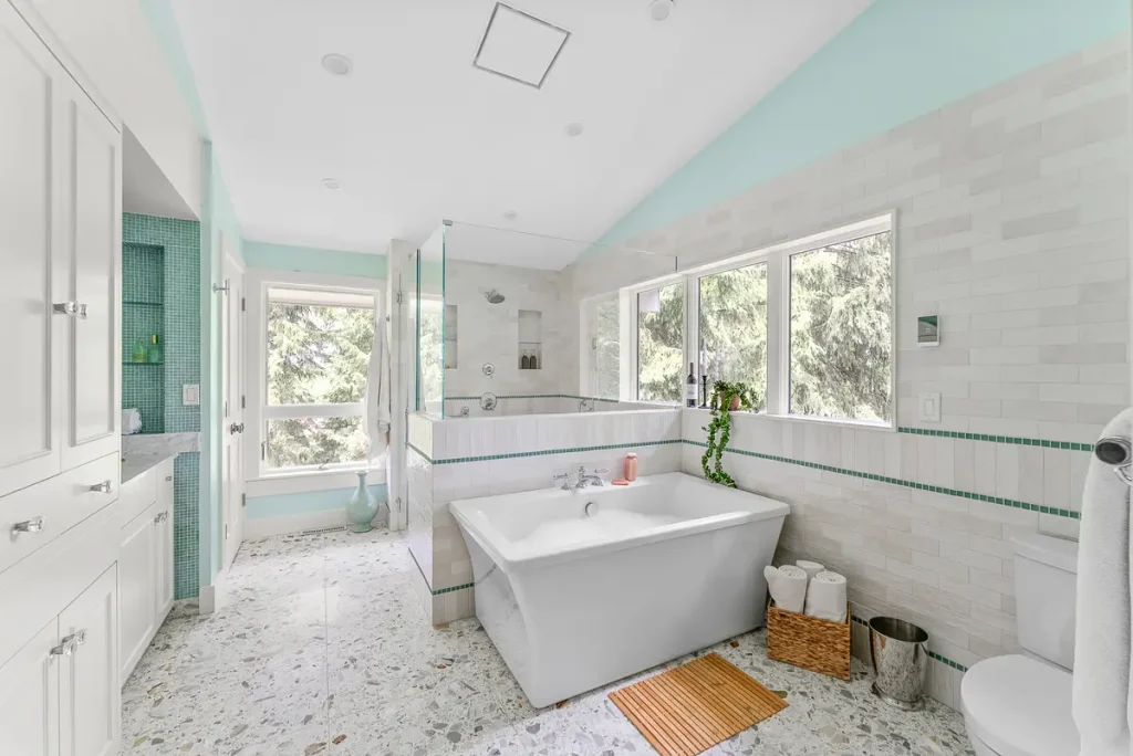 Bright Fox Chapel bathroom renovation with freestanding tub, glass shower and light tile